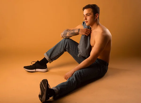 Full body shot of an attractive male model posing in modern style clothing