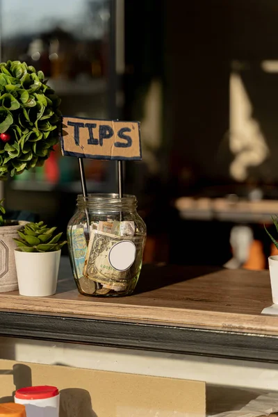 Amazing and small glass tip jar outside in the park, for donations