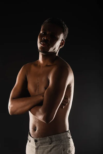 Portrait of topless black male posing in studio