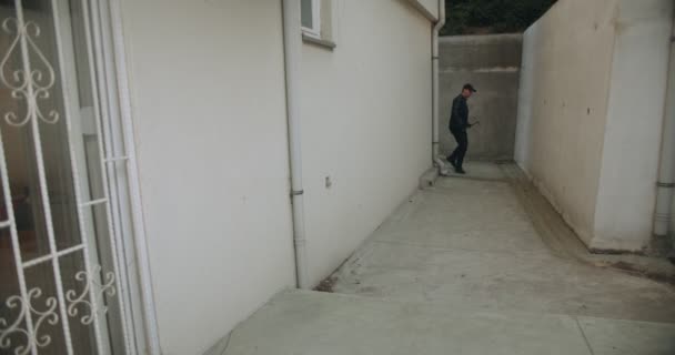 Burglar Opening Metal Door Entering House Backyard — Stockvideo