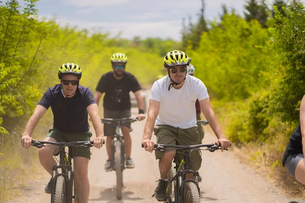 Handsome and fit guys are riding bike together while having a great time