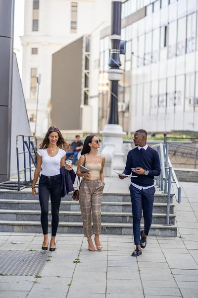 Three Multiracial Workers Smiling Walking Together While Talking — Stock Photo, Image