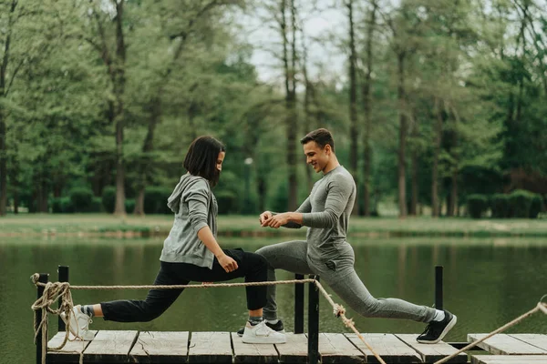 Close Beautiful Couple Streching Together Bridge Park — Φωτογραφία Αρχείου