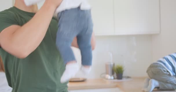 Mother Cooks Background While Father Entertains His Daughter — Stok video