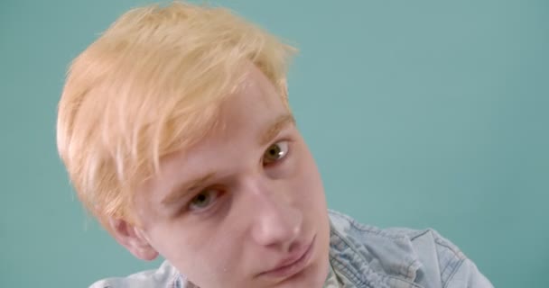 Blonde Boy Chewing Candy While Making Crazy Faces His Tongue — Stock Video
