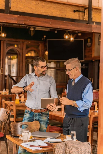 Two Senior Businessmen Looking Some Informations Tablet While Standing Cafe — Photo