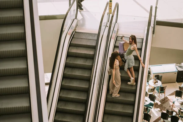 Two Pretty Girls Going Escalator City Mall Shopping While Holding — Fotografia de Stock