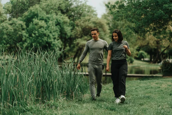 Close Beautiful Sport Couple Walking Park Looking Something Ground Lake — Foto de Stock