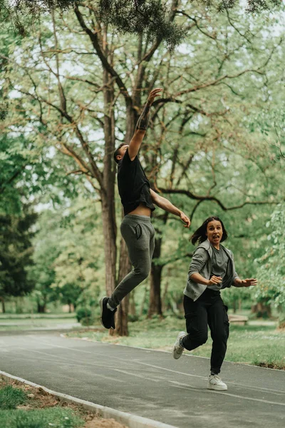 Beautiful Couple Jumping Silver Path While Running Park —  Fotos de Stock