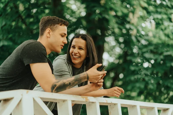 Beautiful Couple Laughing While Leaning White Bridge Park — Stockfoto