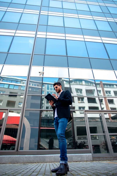 Businessman Texting His Tablet While Standing Infront Building —  Fotos de Stock