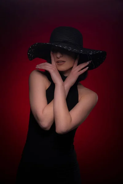 Mysterious Girl Posing Hiding Her Face Hat Red Background — Stock Fotó
