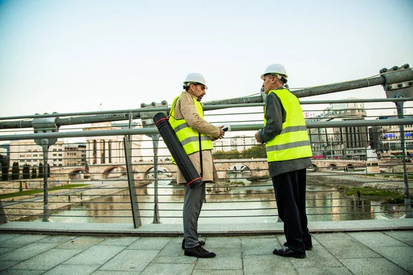 Two Senior Construction Managers Standing Bridge While Talking — Stock fotografie