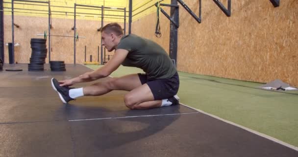 Handsome Guy Stretching His Leg While Changing Positions Stretching — Vídeos de Stock