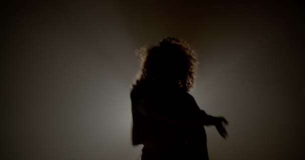 女の子シルエットでスタジオで霧と光線ダンス — ストック動画