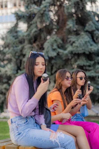 Atractivas Amigas Están Sentadas Banco Tomando Descanso Mientras Lamiendo Helado — Foto de Stock