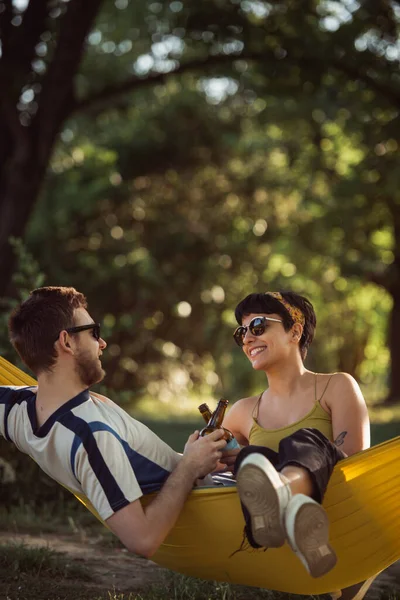 Gyönyörű Pár Beszél Pihennek Egy Sárga Függőágyon Parkban — Stock Fotó