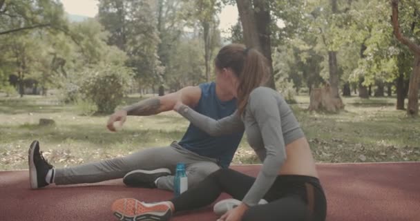 Jeune Couple Buvant Eau Étirant Avant Exercice Dans Parc Scène — Video