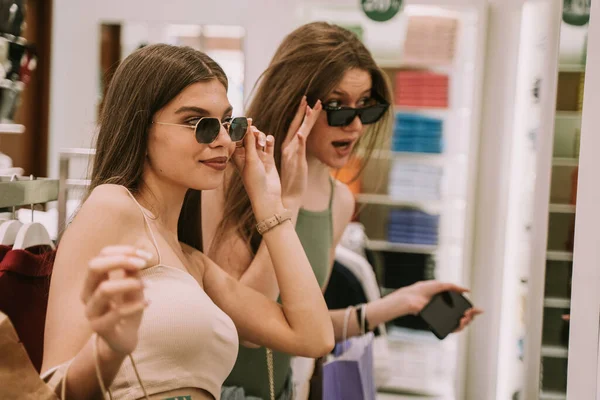 Two Pretty Girls Fashion Store Trying Glasses — Stock Fotó