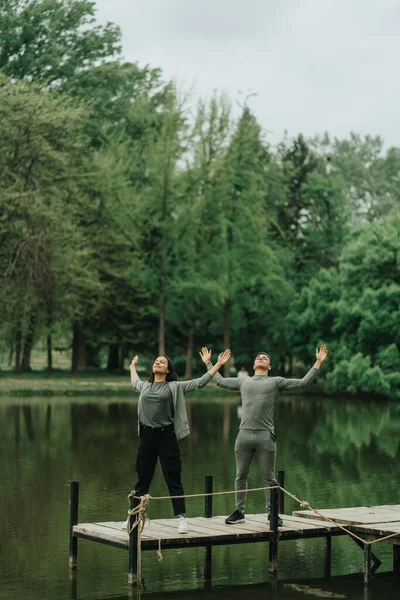 Two Beautiful Best Friends Stretching Arms While Standing Bridge Park — Stock Photo, Image