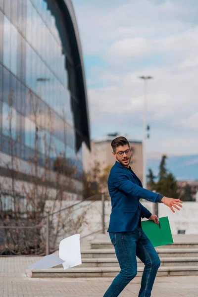 Young businessman with a briefcase running in a city street. Hurrying to work.