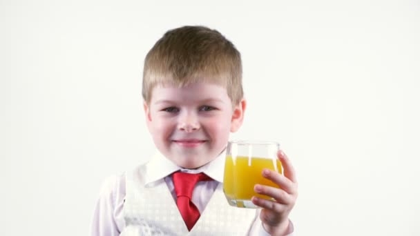 Little boy holding glass of juice — Stock Video