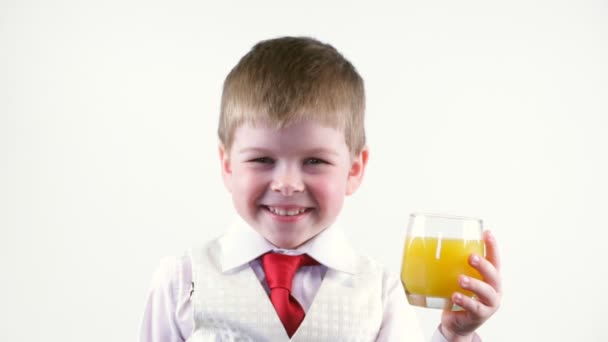 Little boy holding glass of juice — Stock Video