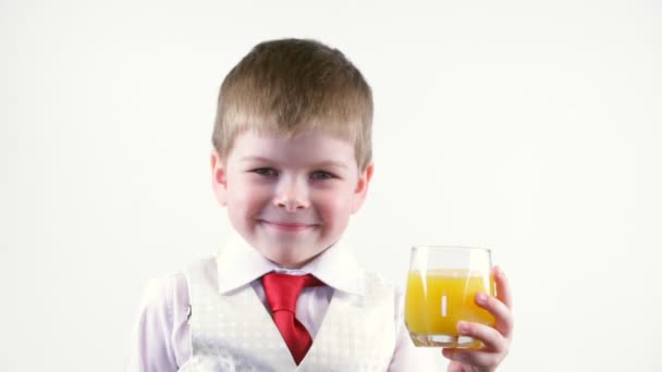 Little boy holding glass of juice — Stock Video