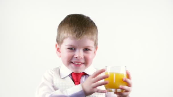 Little boy holding glass of juice — Stock Video