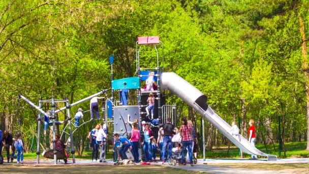 Kids and parents at childrens playground — Stock Video