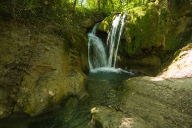 View of little waterfall in the forest near Sarnano, Marche region Italy