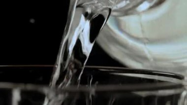 lcohol is poured into a bar glass from a chilled bottle. Close-up, bokeh, rotated subject