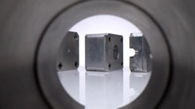 Moving, passing the camera through various plastic and metal parts and forms