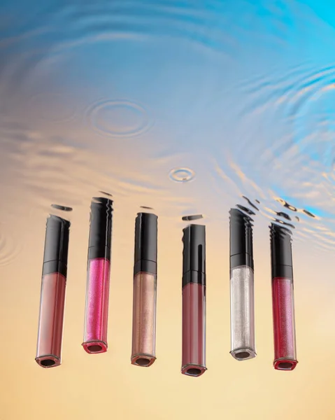 Liquid Lipstick Various Colors Stands Unusual Perspective Background Water Stains — Fotografia de Stock