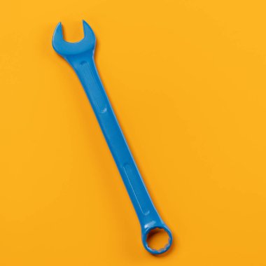 Blue wrench on a yellow background. Pop art concept minimalism