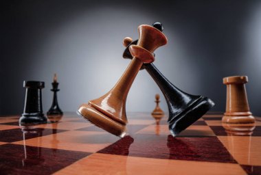 Satranç masası oyun konsepti iş fikirleri ve strateji fikirleri konsepti. Koyu gri arka planda tahta üzerinde satranç figürleri 