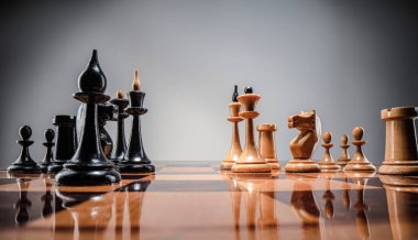 Satranç masası oyun konsepti iş fikirleri ve strateji fikirleri konsepti. Koyu gri arka planda tahta üzerinde satranç figürleri 