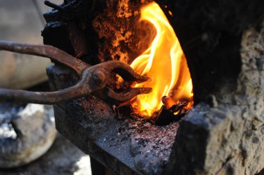 Almaty, Kazakhstan - 09.24.2015 : A homemade melting pot with fire for forging metal.