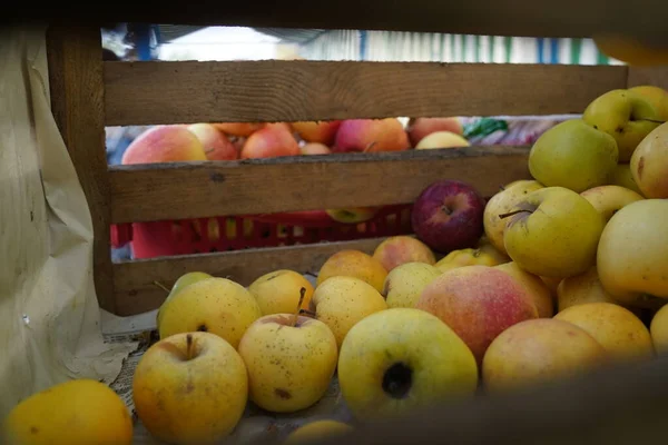 Apples of different varieties on sale at the market.