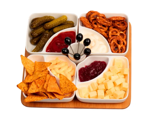 Bowls with snacks on bamboo tray — Stock Photo, Image