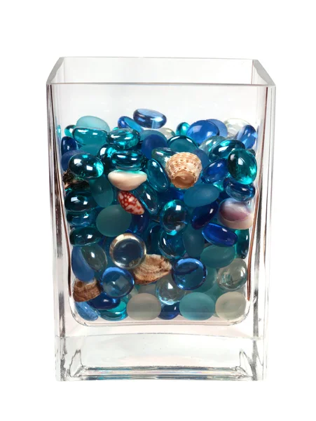 Blue glass pebbles and seashells in the glass — Stock Photo, Image
