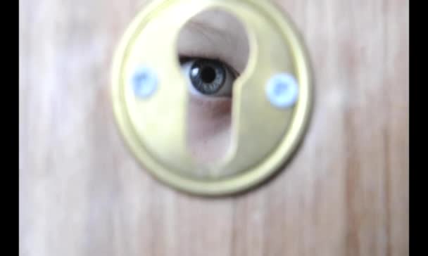 Eye in a keyhole — Stock Video