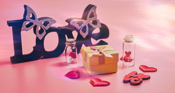 Gift box with beautiful red ribbon and rose, concept of Valentine's, anniversary, mother's day and birthday greeting, copyspace, topview. Flat lay, top view, copy space