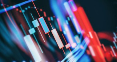 Bilgisayar ekranında finansal grafikler, öncü ekranda borsa grafiği. Finans ve yatırım konsepti. Seçici odak.