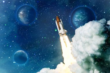 Space shuttle rockets launch into space on the starry sky. spacecraft flies into space with clouds of smoke.  Elements of this image furnished by NASASpace shuttle rockets launch into space on the starry sky. spacecraft flies into space with clouds o