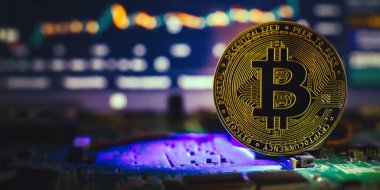 Cryptocurrency concept , Golden bitcoin on mainboard , The future of money. Computational equipment.