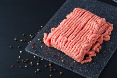 Bir tabakta taze kıyma. Köy ahşap bir masaya yakın..