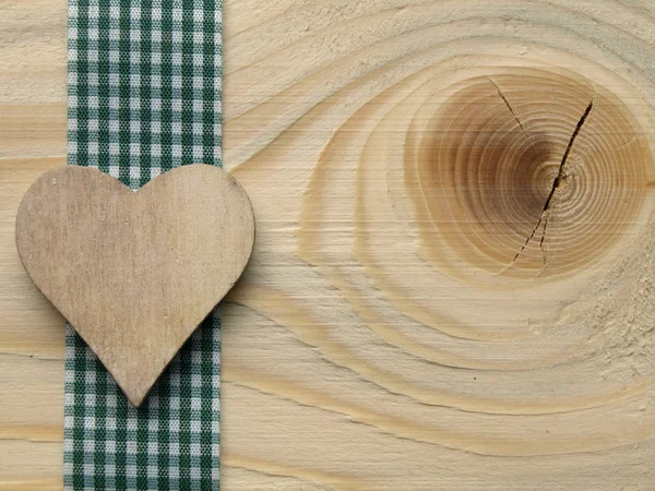 Wooden background with a checked ribbon — Stock Photo, Image