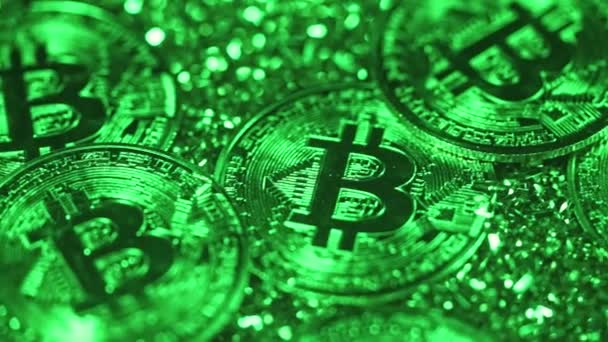 人気のある暗号通貨ビットコイン。コインは緑色の光の下で時計回りに回転する。市場取引利益、鉱業、投資、サイバー空間の概念。クローズアップ詳細背景 — ストック動画