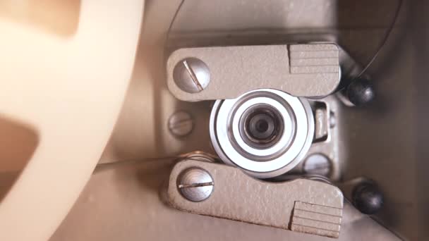 Close-up gedetailleerde weergave van het werkproces retro ouderwetse 8mm projector afspelen rollen met tape film. Spoel draaien. Vintage voorwerpen, amusement, nostalgie, festivalmateriaal — Stockvideo